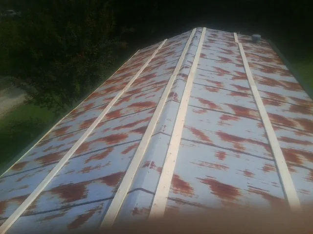 Rusted metal roof panels with new wood purlins before replacement — Storm Damage Roof Repair in Pearl River by Roofing Brothers